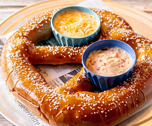 A warm and soft salted pretzel served with two different dipping sauces at Rapids Riverside Bar & Grill in South Range WI.