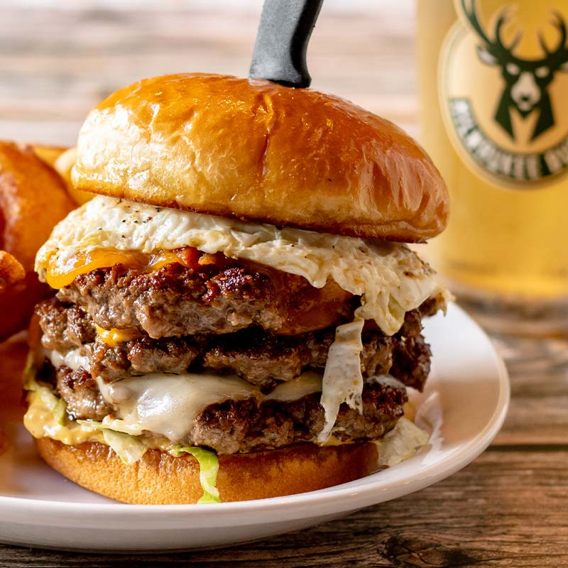 Triple cheeseburger with lettuce and fried egg, served at a restaurant near Amnicon Falls.