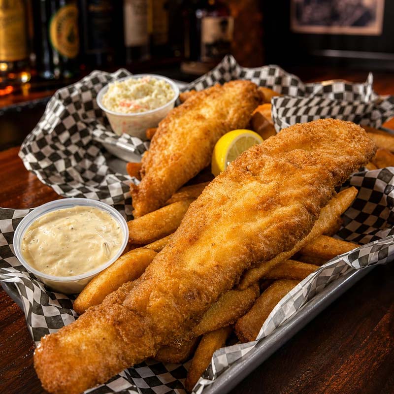 Crispy Rapids Riverside Friday Fish Fry with fries, tartar sauce, and coleslaw in baskets.