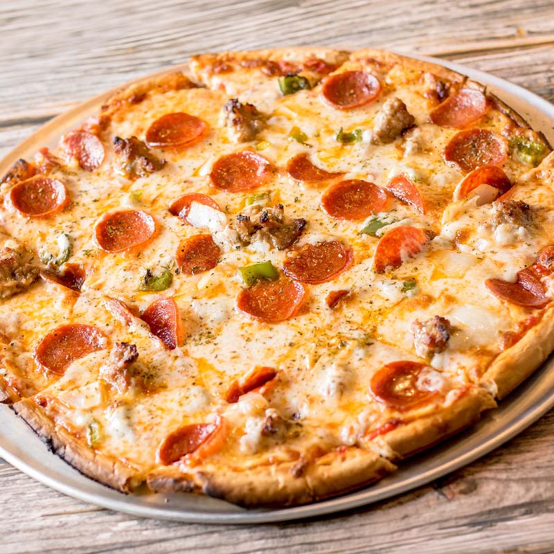 A baked pizza with pepperoni and veggies, served hot at a restaurant near Amnicon Falls.