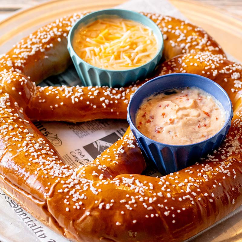 Giant salted pretzel with two dips, served on newspaper at this restaurant near Amnicon Falls.